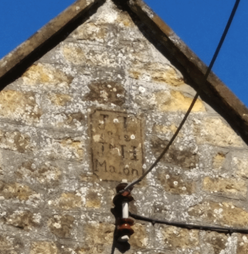 The datestone high up in the Footfalls gable end.